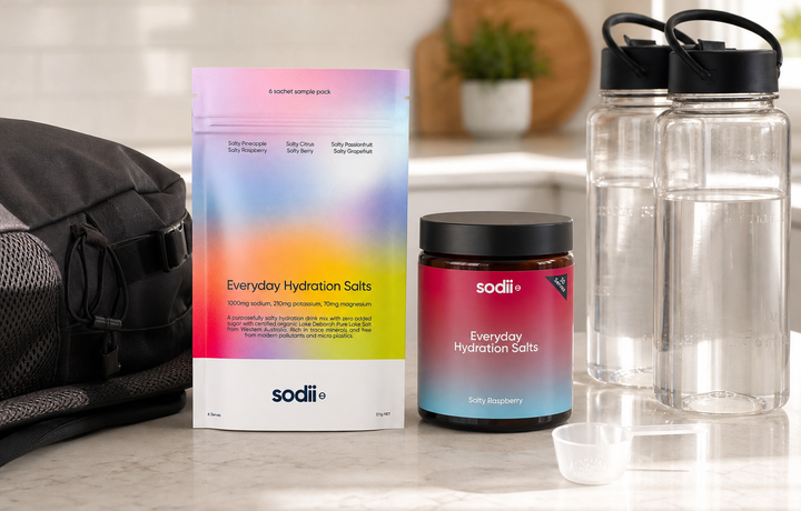 Electrolyte sachets and a tub compared beside water bottles and a day bag article image