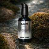 Monday Sunday Calm Oral Drops bottle in a natural stream setting