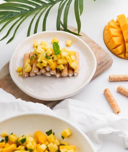 Serving suggestion: original coconut wafer rolls filled with coconut cream and topped with tropical fruit