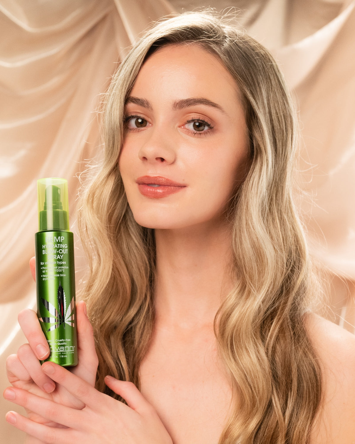 Model holding Giovanni Hemp Hydrating Blow-Out Spray 118ml
