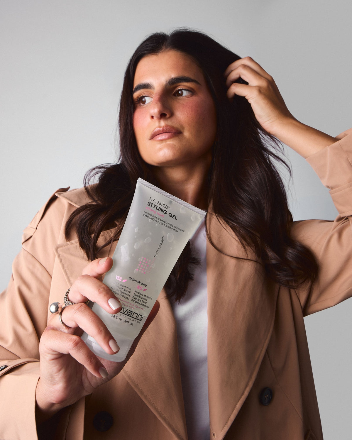 Model holding Giovanni L.A. Hold Styling Gel 200ml beside her hair
