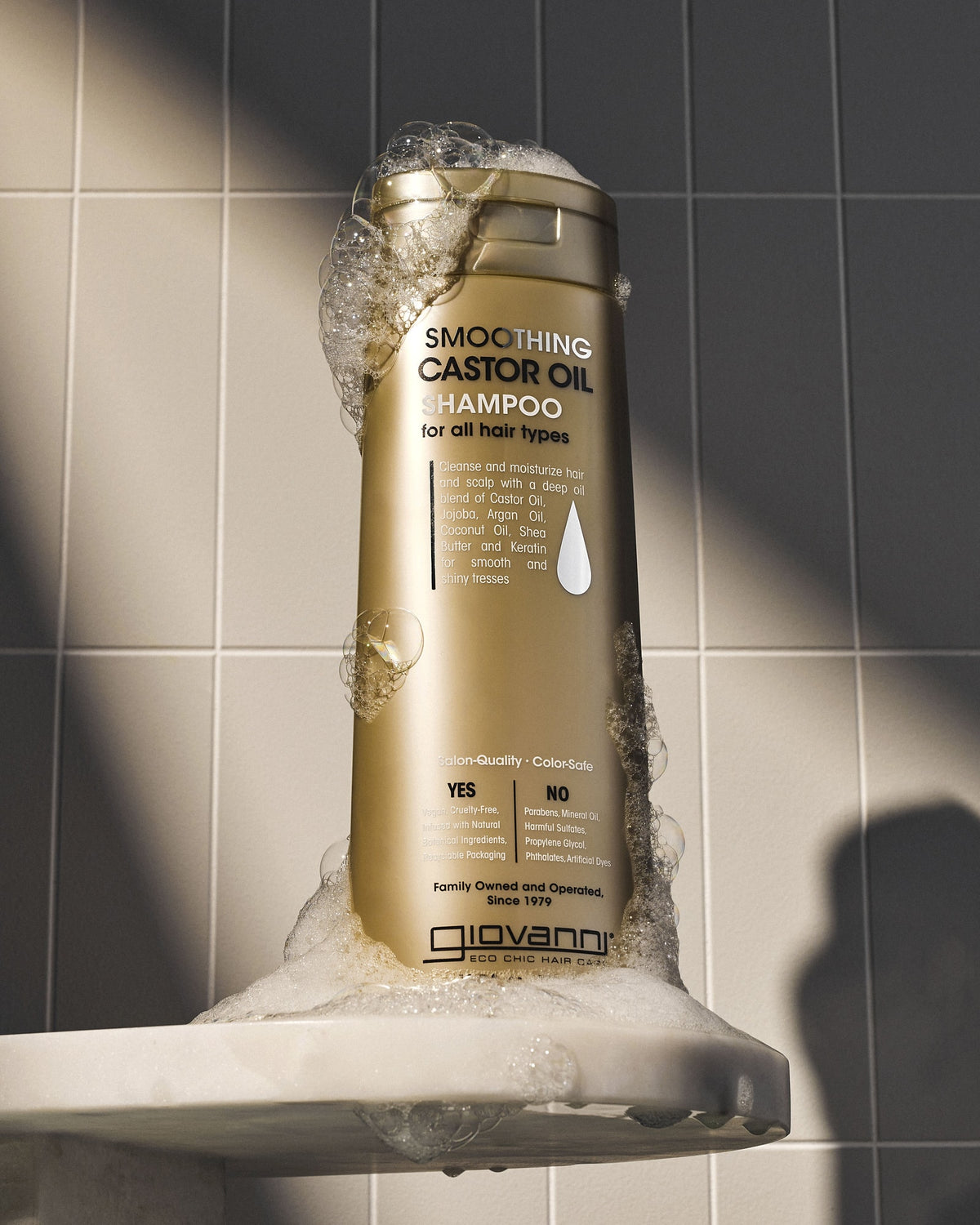Giovanni Smoothing Castor Oil Shampoo 399ml with lather in a tiled shower
