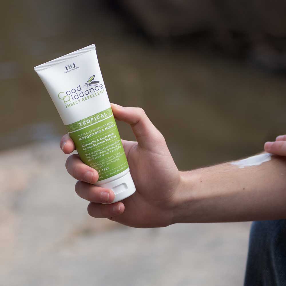 Good Riddance Tropical 100ml tube held while applying cream to an arm