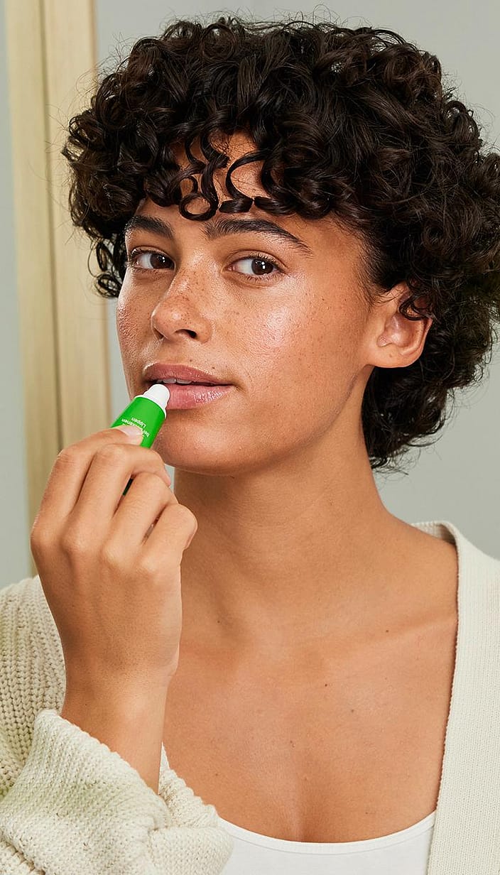 Weleda Skin Food Lip Balm applied to the lips